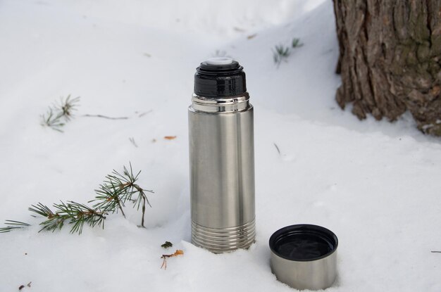 Winter tourism. thermos in the snow.