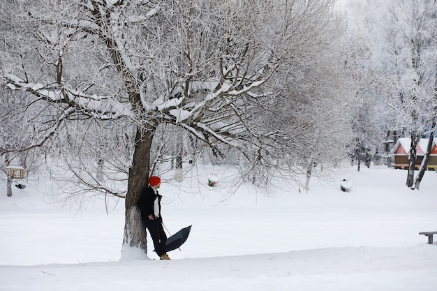 Winter walk with an umbrella.Man in a coat with an umbrella, walk against the backdrop of the winter landscape, winter view