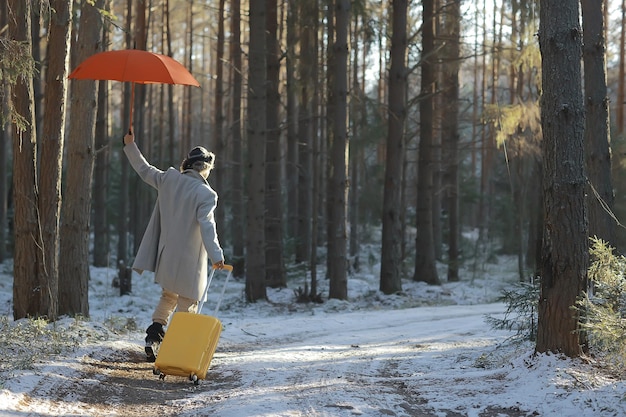 winter walk with an umbrella / man in a coat with an umbrella, walk against the backdrop of the winter landscape, winter view