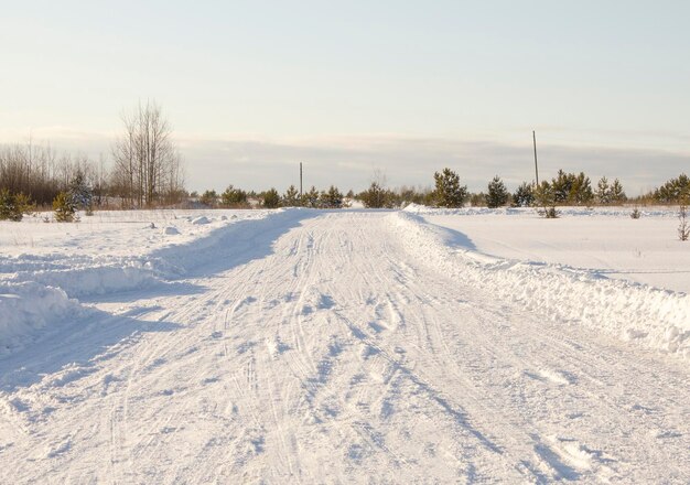 Winter weg bedekt met sneeuw in het veld