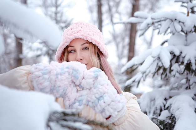 Winter woman in snow looking at camera outside on snowing cold winter day Portrait Caucasian female model outside in first snow