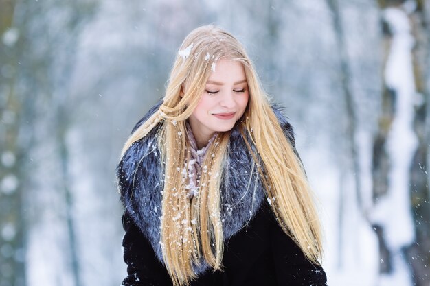 Winter young teen girl portrait. Beauty Joyful Model Girl laughing and having fun in winter park