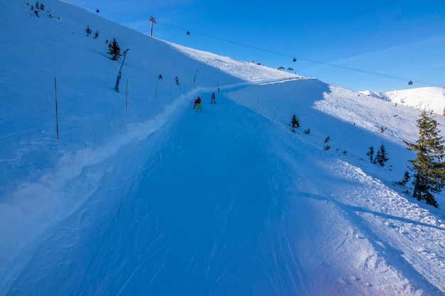 Winter zonnige dag in het skigebied. Zachte skibaan voor beginners om een grote boog af te skiën