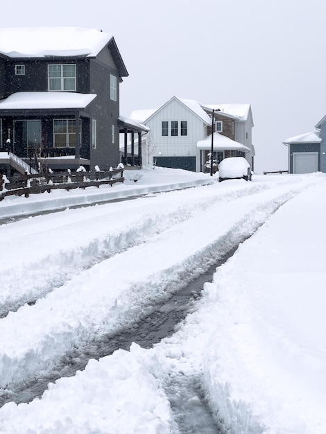 Wintery residential street with snowcleared driveway and sidewalk