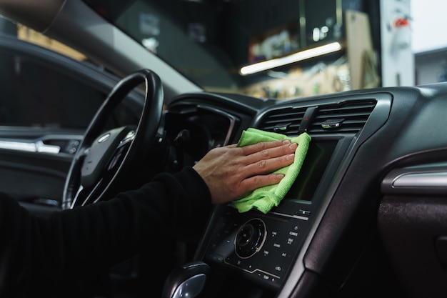 Wiping dust in car. Car cleaning. Wet car cleaning