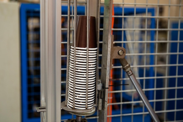 A wire cart with a coffee cup on it