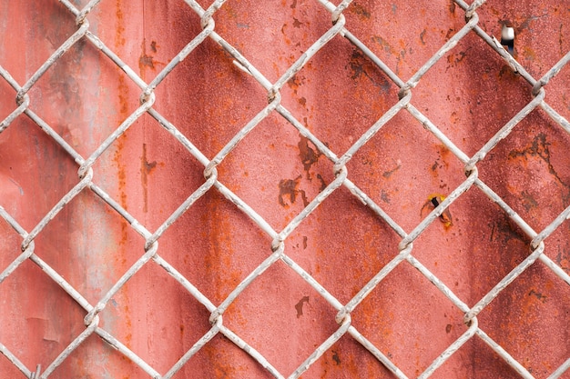 Wire Mesh and red corrugated fence  background