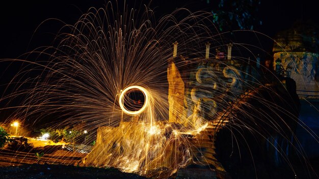 Wire wool against sky at night