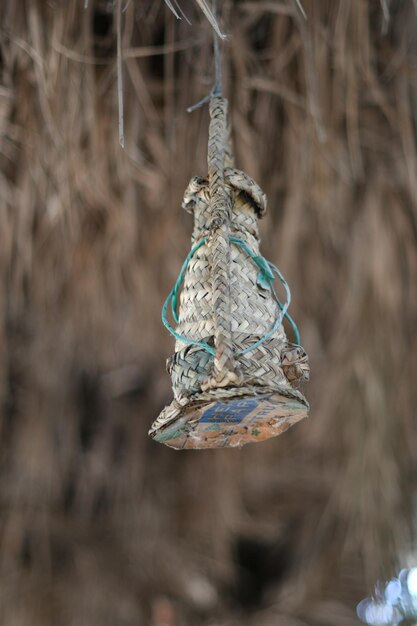 A wire wrapped around a pole with blue wire.