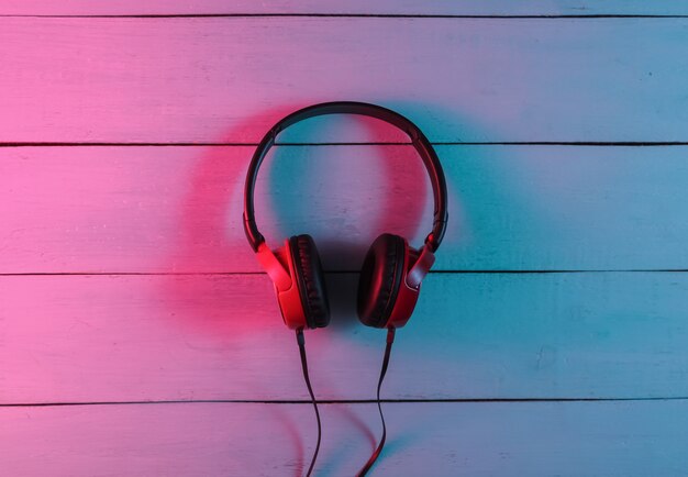 Wired headphones on wooden background