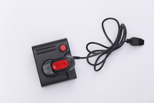 Wired retro joystick with wound cable on white background. Video game, gaming. Top view