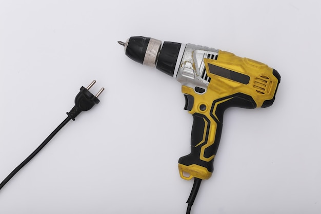 Wired used drill screwdriver on white background. Top view