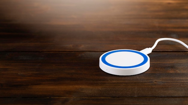 Wireless device charger on rustic wooden desk Stock image with copy space