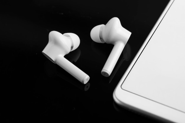 Wireless ear buds or headphone with smartphone technology concept