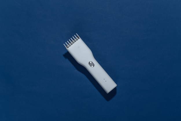 Wireless hair clipper on classic blue.