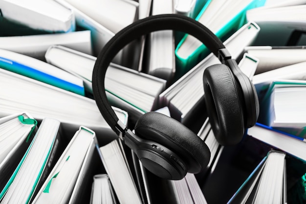 Wireless overhead black headphones lie on the books