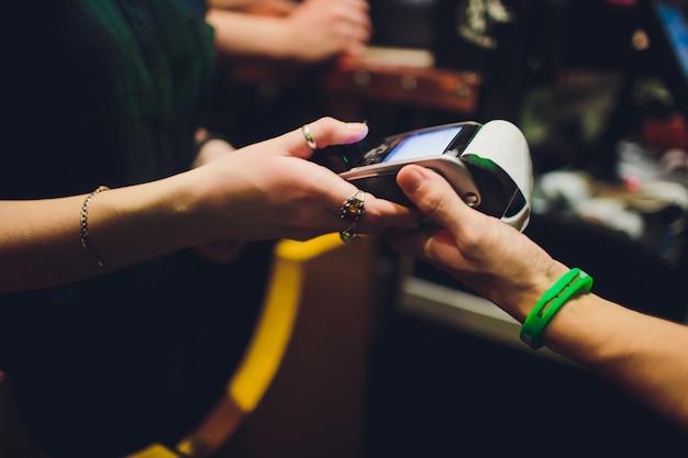 Wireless payment for buying a smartphone in the store through the payment terminal.