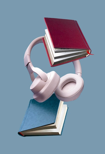 Wireless white headphones and hardcover books fly on a blue background