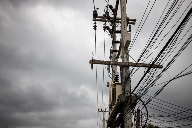 Wires attached to the electric pole the chaos of cables and wires on an electric pole in asian