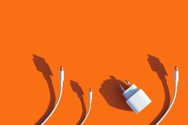 Photo wires and charger for the phone on a bright orange background