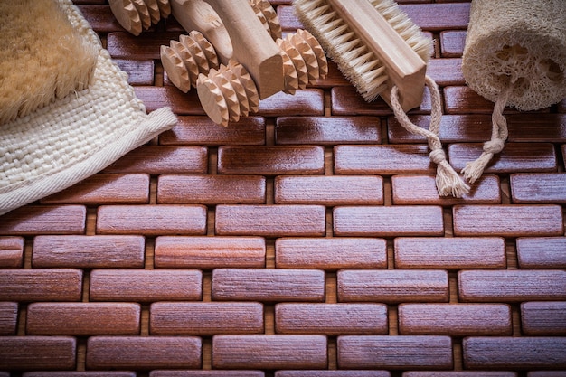Wisp of bast loofah wood peeling brush and massager on textured wooden place mat sauna concept