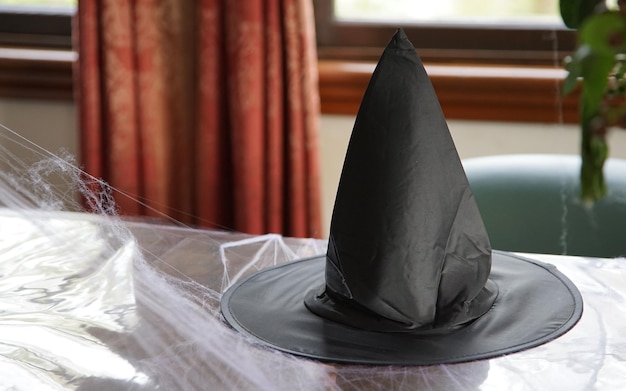 Witch black pointy hat on the table