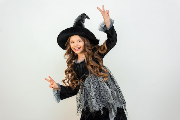 Witch costume for carnival A child in a black Halloween outfit