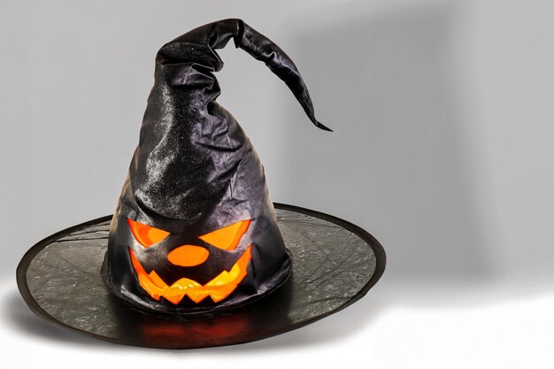 Witch hat with pumpkin for Halloween on gray background with space for text