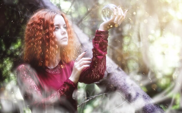 Photo witch holds a ritual in the depths of the forest