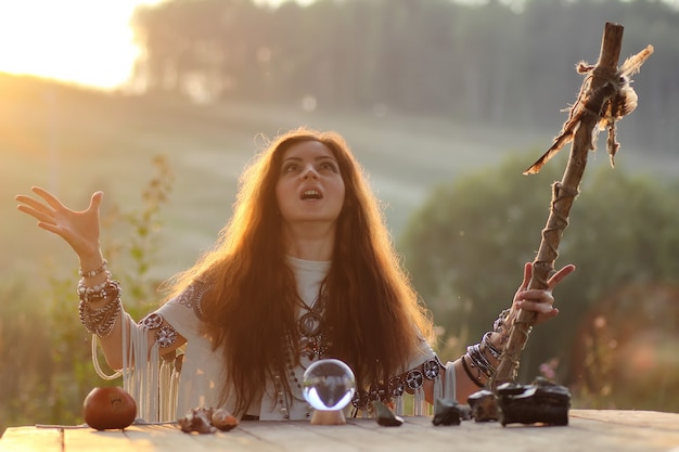 Photo witch with crystal ball at sunset