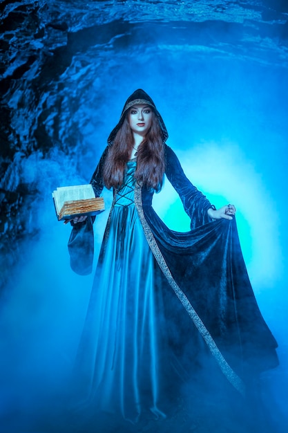 The witch with magic ball in her hands causes a spirits