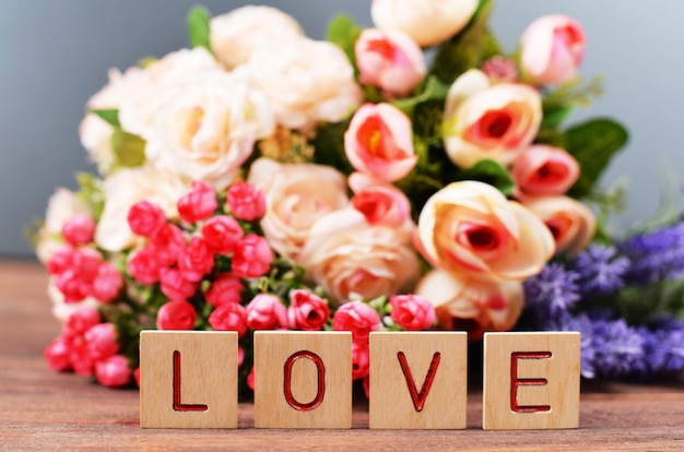  with flowers with gift box on holiday valentine's day mother's day with wooden letters tex