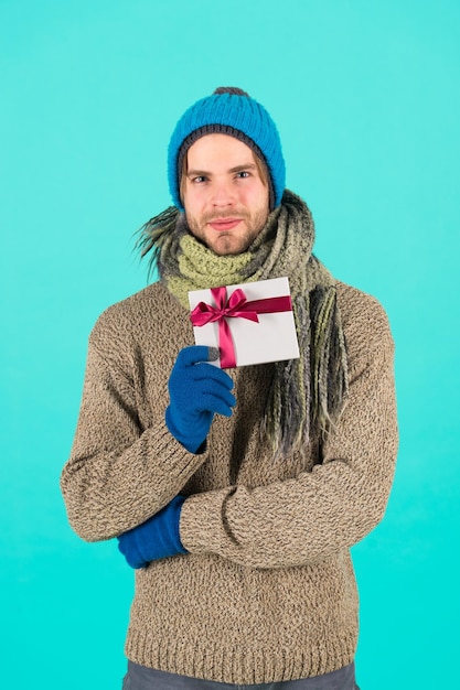 With love for you man bearded handsome wear winter hat scarf
gloves hold gift box hipster hold christmas gift with bow
valentines day concept winter holidays give gift spread
happiness