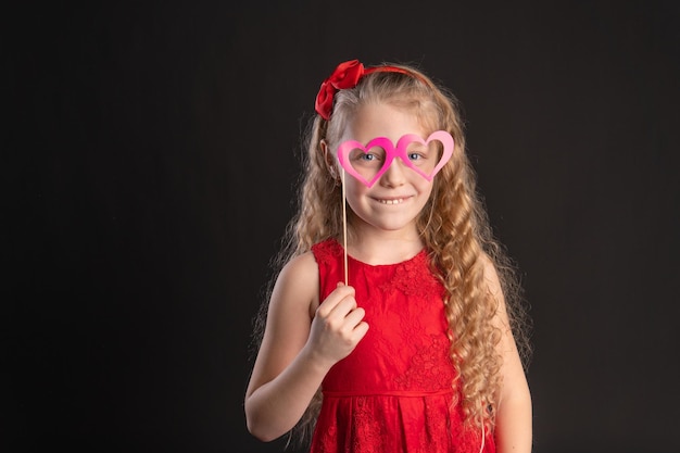 With the mask glasses Valentine red hearts happiness flirting on the floor hearts married the space the formula of art emotion feeling engagement in red dress girl barefoot