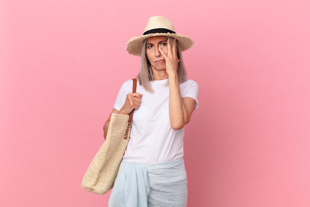 Witte haarvrouw van middelbare leeftijd die zich verveeld, gefrustreerd en slaperig voelt na een vermoeiende zomer concept