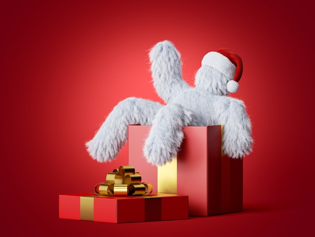 Witte harige yeti draagt kerstmuts zit in de grote geschenkdoos