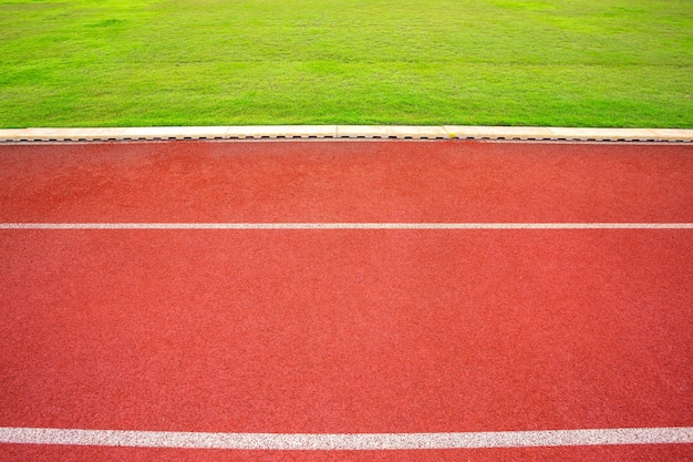 Witte lijnen van stadion en textuur van rennende renbaan rode rubberrenbaan.