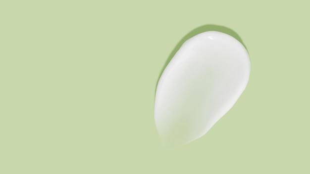 Witte schoonheidscrème uitstrijkje vlek op groene achtergrond Cosmetische huidverzorging producttextuur