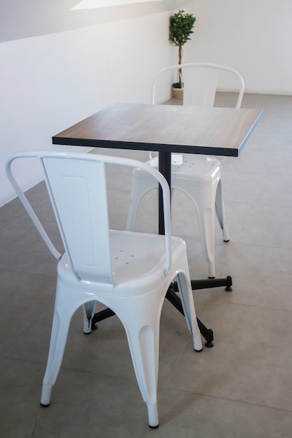 Witte stalen stoel en houten tafel