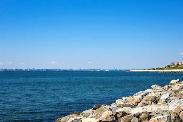 Witte stenen strandrotsstrand met een blauwe lucht en helder water aan de oceaan