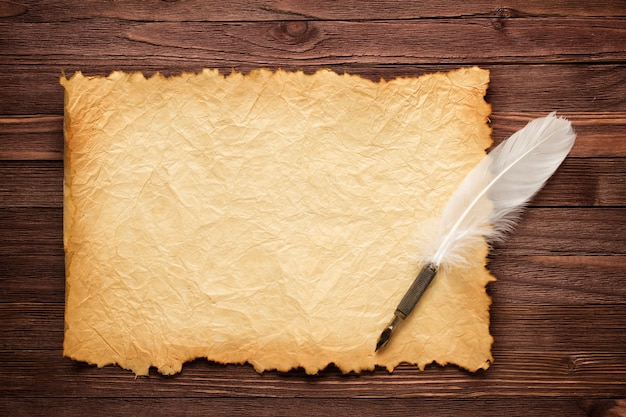 Witte veren en oud papier op hout oppervlak