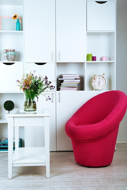 Witte woonkamer met fauteuil en boekenkast