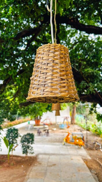 Photo woden basket electrical lamp in green background