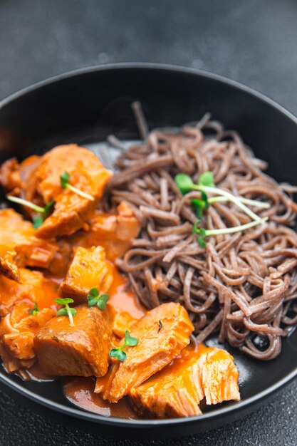 Wok noodles soba buckwheat meal tomato sauce meat food snack on the table copy space food