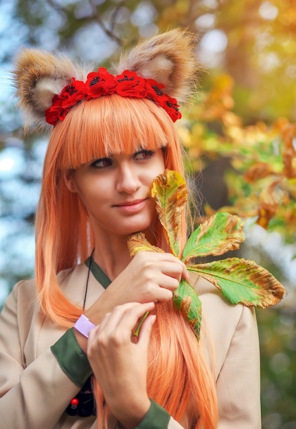 Wolf girl cosplay character in autumn park. Anime festival