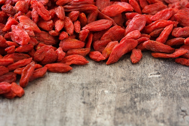 Wolfberries or Goji berries on wooden table Copy space