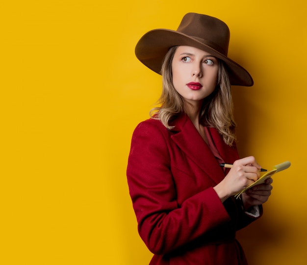 Woman in 1940s style clothes with note and pen