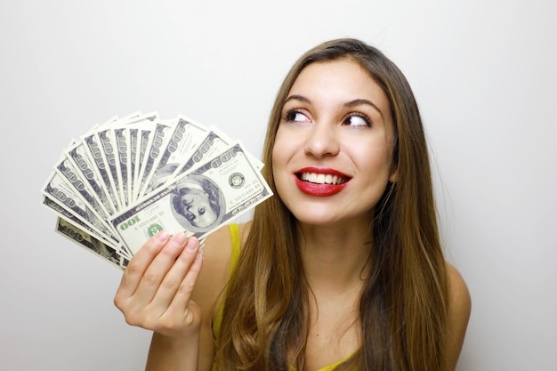 Woman 20s holding fan of money in dollar cash