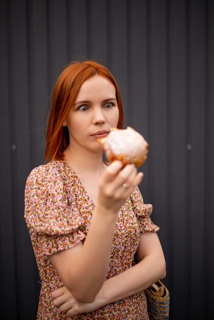 Woman 40 years old eating a bun