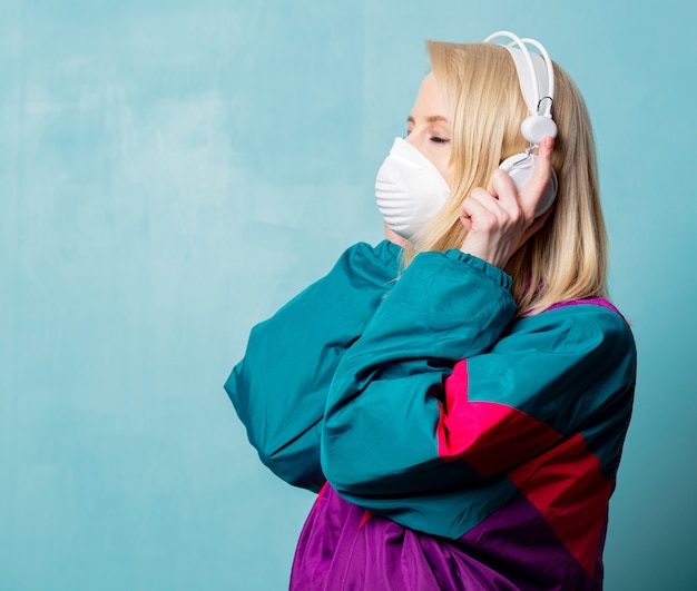 Woman in 90s clothes and face mask with headphones